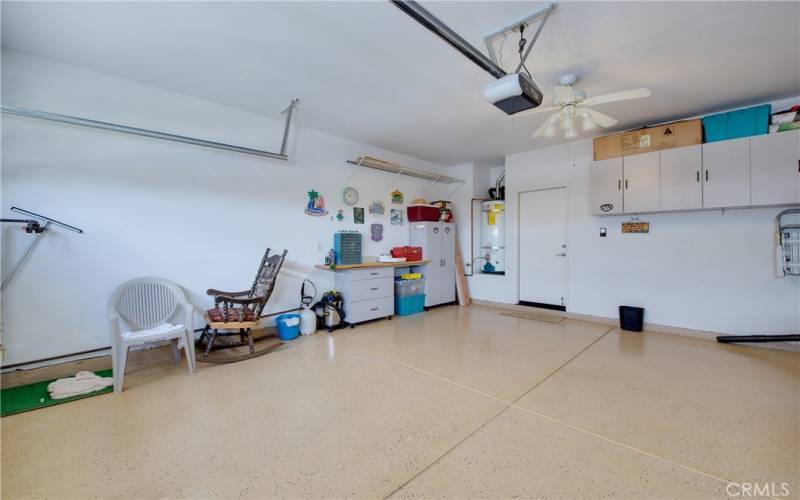 Spotless 2-car finished garage with epoxy floor and storage cabinets.