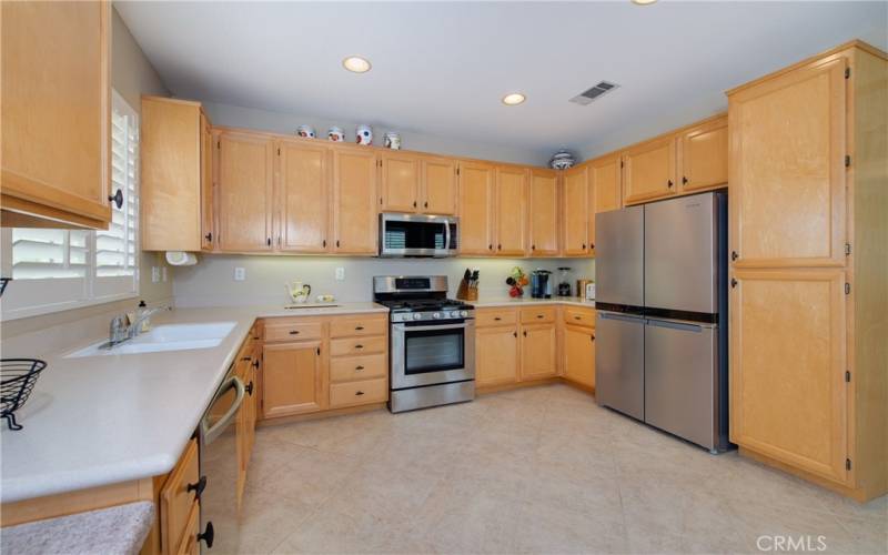 Kitchen with included high-end refrigerator. Pantry on right.