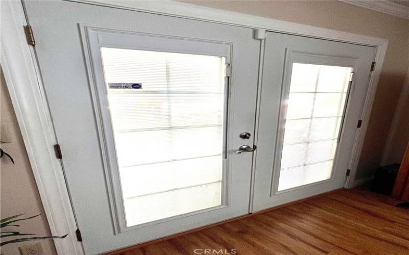 Family room dual pane french doors with encased blinds