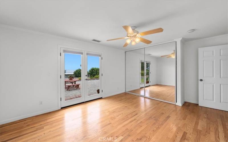 Bedroom #4 with French Doors leading out to backyard patio.