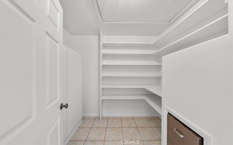 Extra Hall Storage Closet with built in shelving, cabinet storage, file cabinet, and safe.