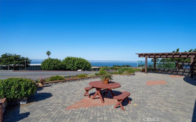 Outdoor patio with pergola, landscaping, pavers, BBQ, and views of the ocean and Catalina.