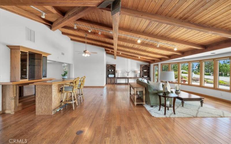 Living Room featuring expansive windows, providing abundant, natural light, along with sunrise and ocean views.