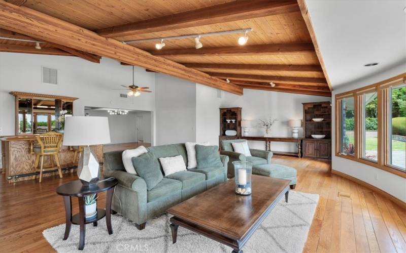 Living Room featuring expansive windows, providing abundant, natural light, along with sunrise and ocean views.