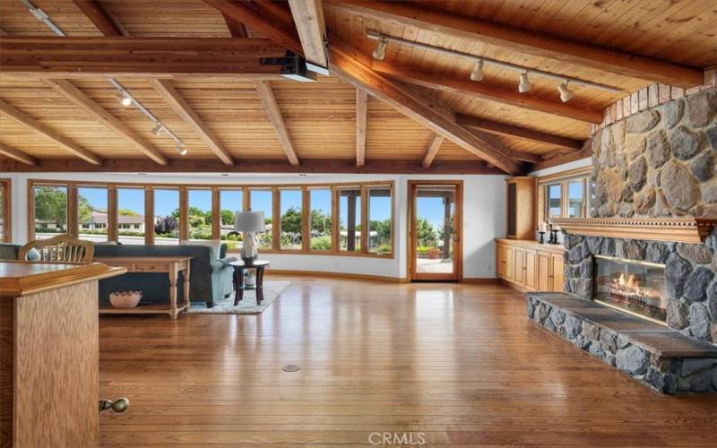 Living Room featuring expansive windows, providing abundant, natural light, along with sunrise and ocean views.