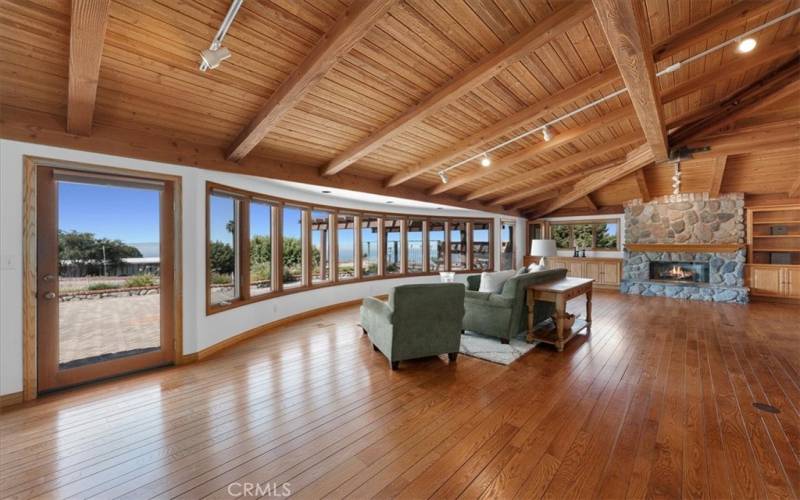 Living Room featuring expansive windows, providing abundant, natural light, along with sunrise and ocean views.