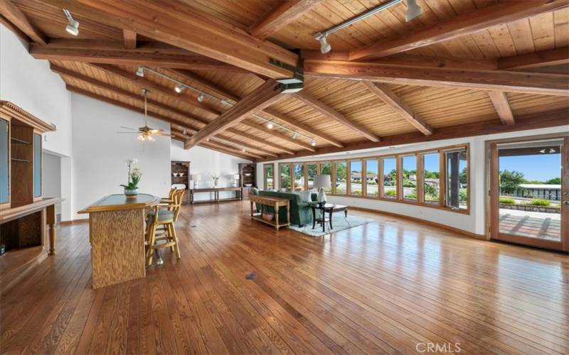 Living Room featuring expansive windows, providing abundant, natural light, along with sunrise and ocean views.