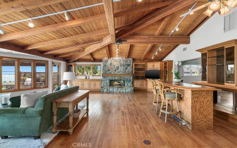 Living Room featuring expansive windows, providing abundant, natural light, along with sunrise and ocean views.