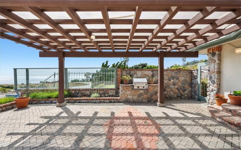 Outdoor patio with pergola, landscaping, pavers, BBQ, and views of the ocean and Catalina.