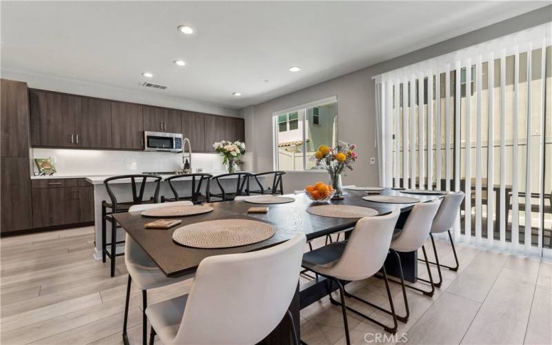 SPACIOUS DINING AREA WITH CUSTOM DESIGN SMART DRAPES.