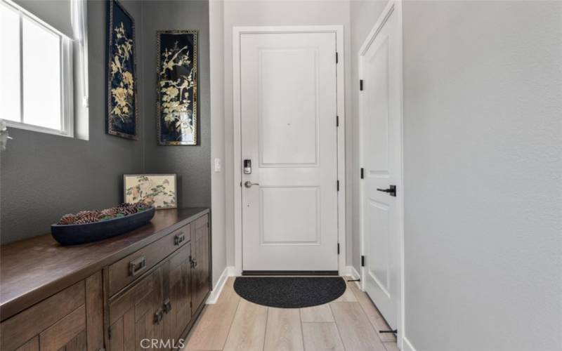 ENTRY WITH RIGHT SIDE FOYER AREA. DESIGNER VINYL PLANK FLOORING.