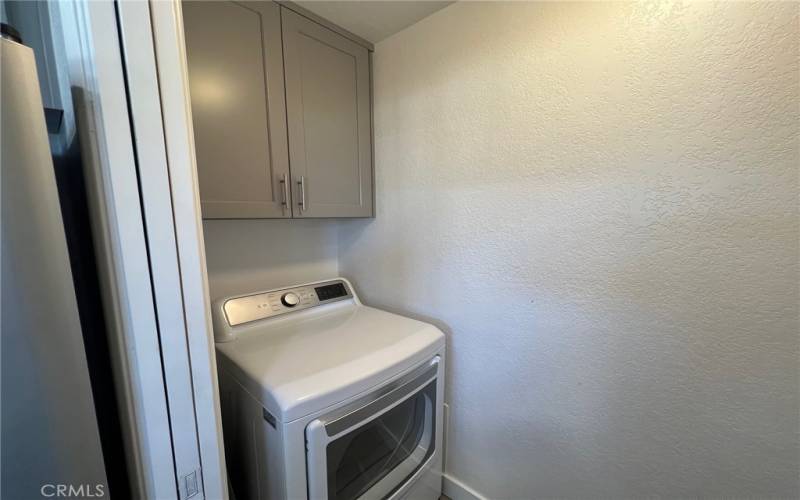 Inside laundry with cabinets