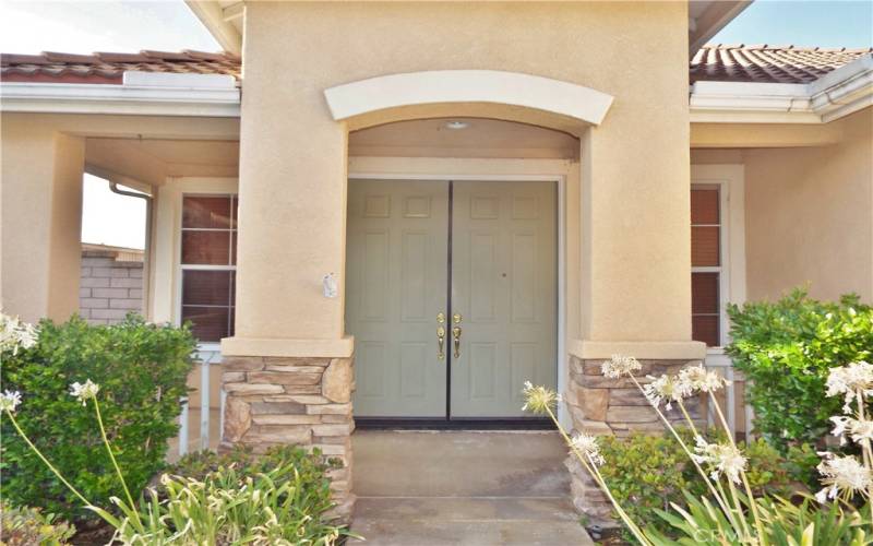 Inviting wrap around covered front porch. Double door entry.