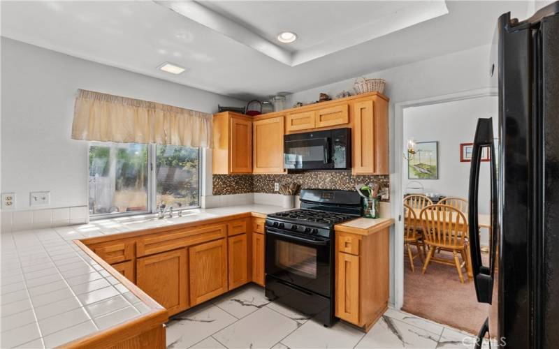 Kitchen with new flooring and refaced cabinets