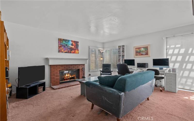 Family Room with Wood Burning Fireplace and Shutters