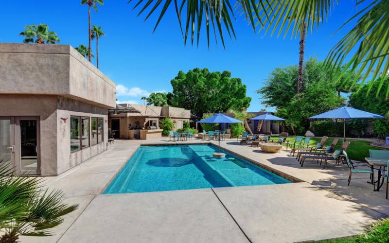 BACK YARD WITH POOL AND LOUNGES