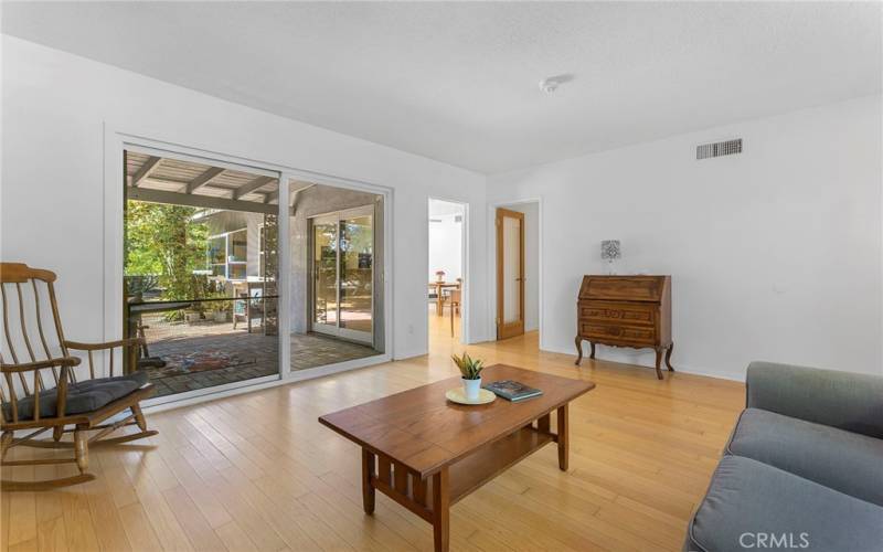 Living room and dining area both with access to back patio