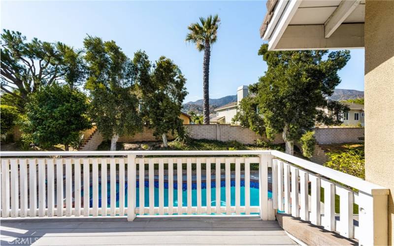 and a private balcony, overlooking the pool and greenery