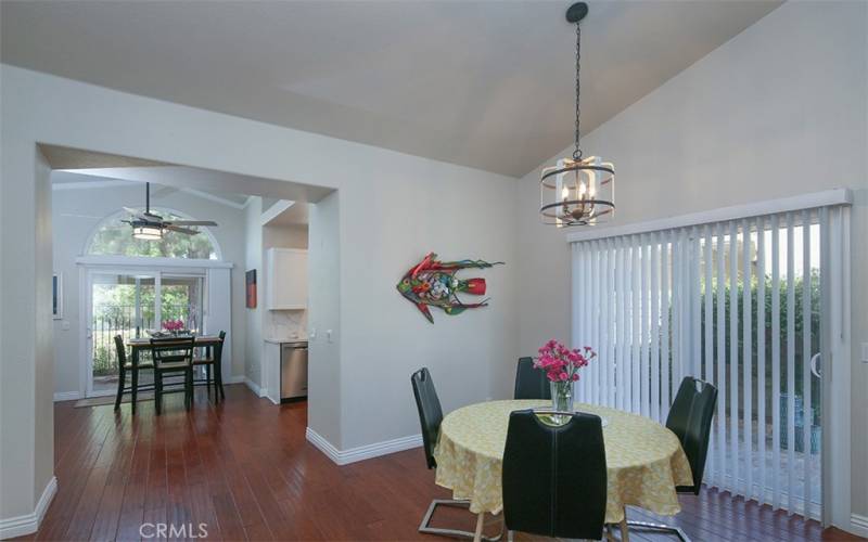 Dining Room with view to the kitchen and side door to side courtyard