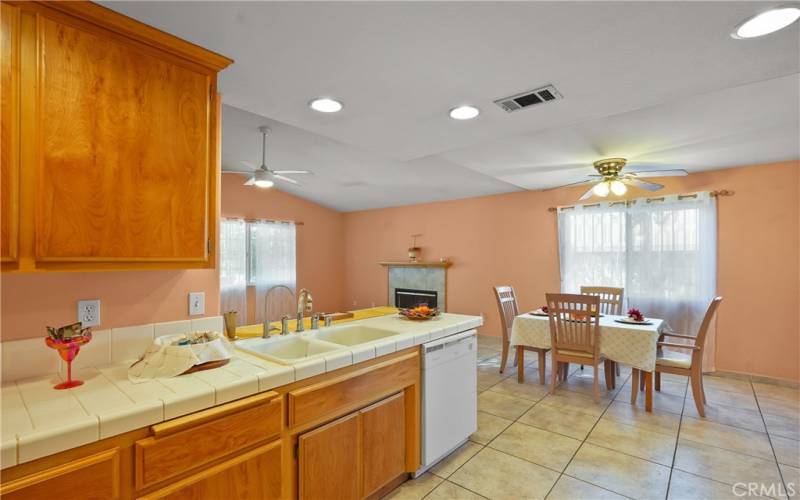 KITCHEN WITH VIEW OF DINING AREA AND FIREPLACE.