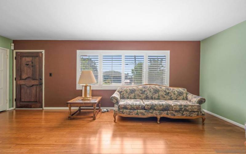 Front door is to the left.  The house sits higher than the sidewalk so you can enjoy watching the world go by from the living room without having passersby looking in.