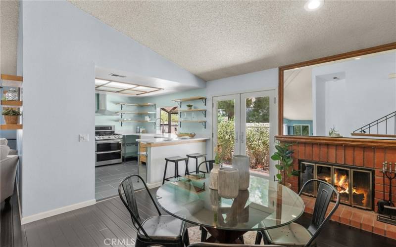 dining area with fireplace open to kitchen