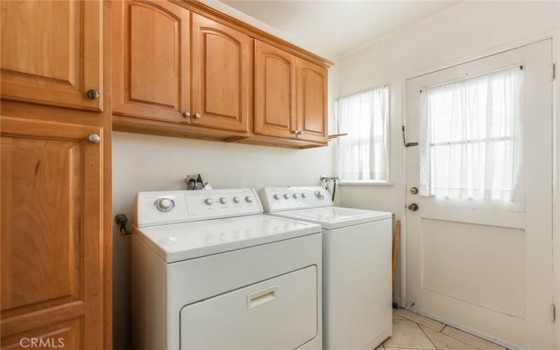 Laundry with door to side of house