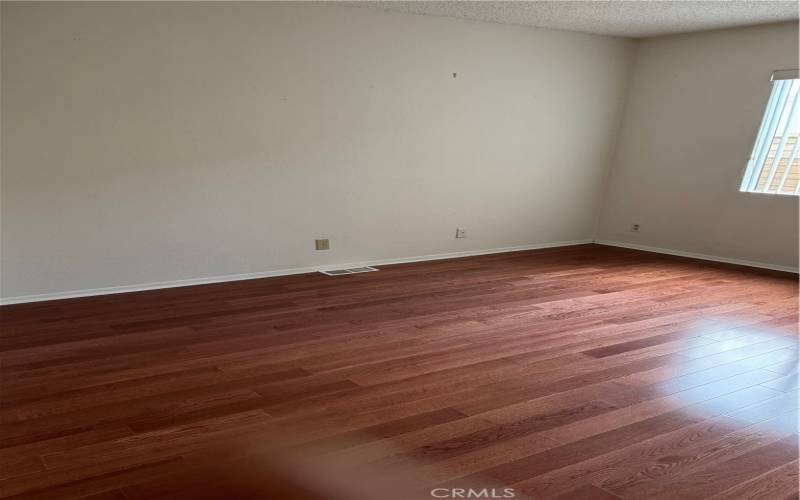 Bedroom 2 features gleaming wood-like flooring