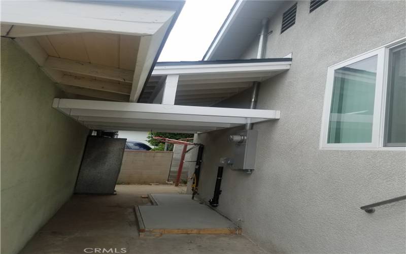 Covered Passageway Between Front Unit and Back Unit- Laundry Hook up Area for Front Unit and Water Heater Location