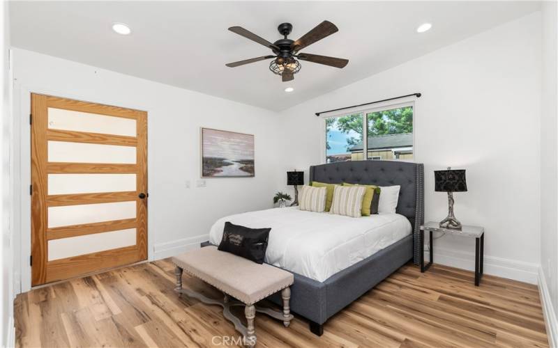 This primary bedroom was added to the home in the late 1950's. It has a door to the back patio, as well as an en- suite bathroom.