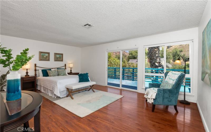 The primary bedroom is a large room with sliding doors leading to the balcony. The views of the Box Springs Mountains from here are wonderful.