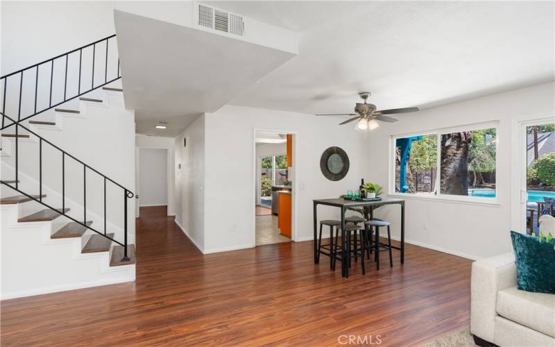 The living room seamlessly turns into your dining area. The stairs lead to the second floor, and the hallway connects the living room to the familyl room and the downstairs bedroom and bathroom.