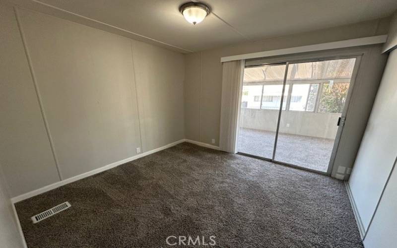 Guest Bedroom with sliding glass door to enclosed patio.