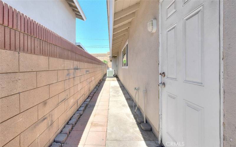 Side yard with block walls all around.