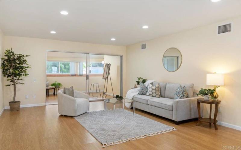 Spacious living room seamlessly connects to enclosed patio