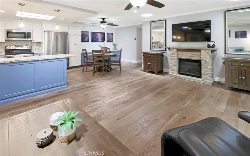 Designer custom cabinets in kitchen with two ceiling fans in open concept area