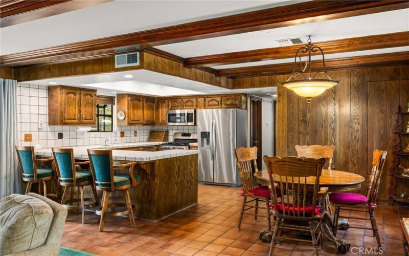 Kitchen with barstool seating and table area