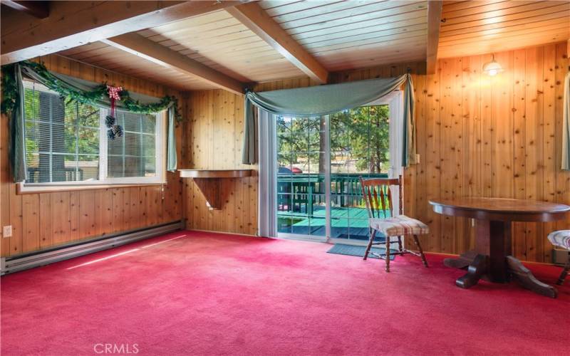 Beautiful Knotty pine with great natural lighting looking out to a large deck and spa