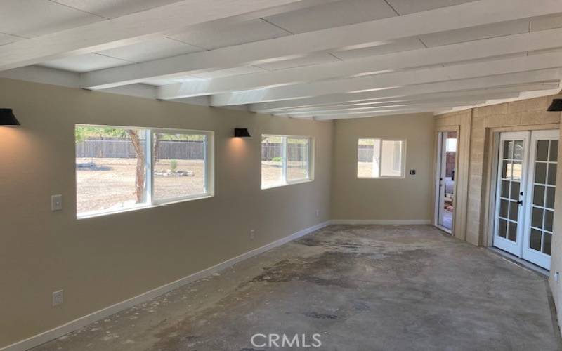 Patio Room with garage entry door and 3rd bedroom French doors