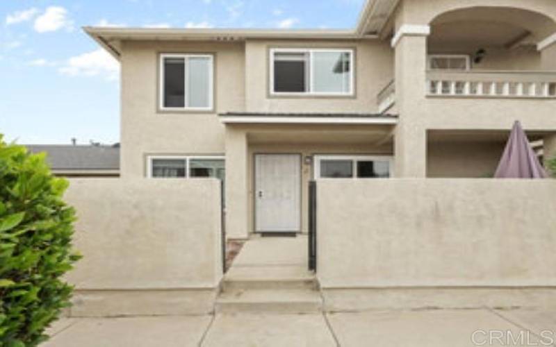 Entrance to unit via privacy gate and patio