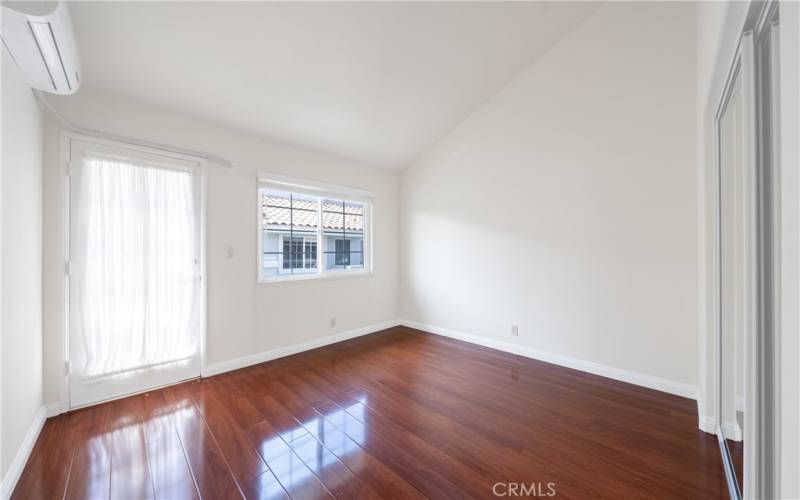 Guest bedroom 3, with AC wall unit and shared balcony.