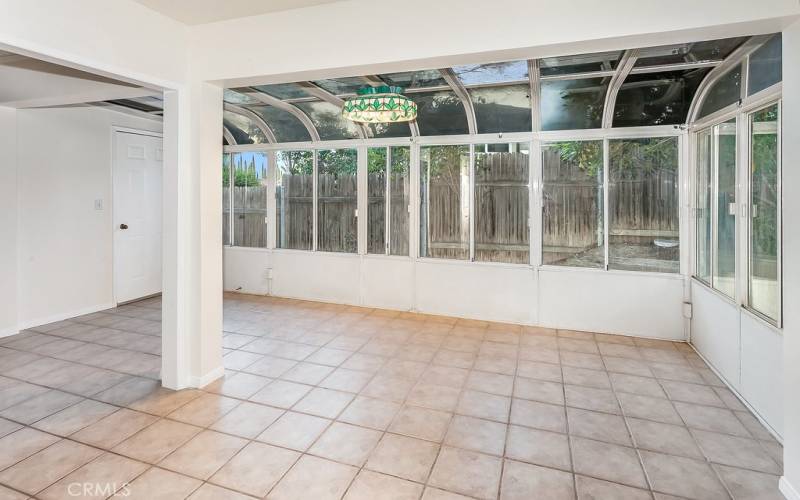 A stunning open and bright atrium/sunroom that invites the outdoors in and offers a multitude of designing opportunities.