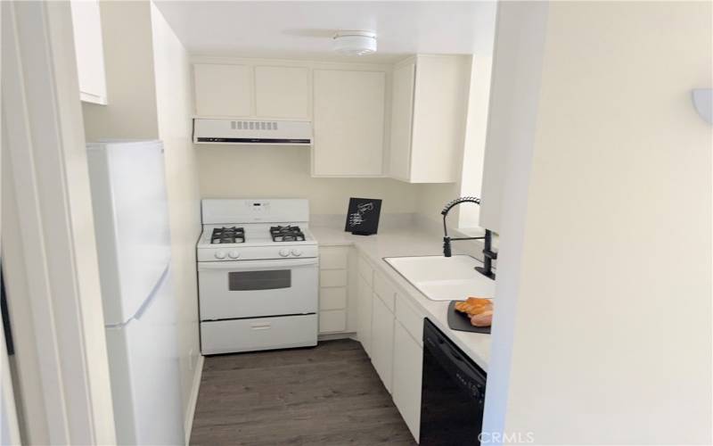 KITCHEN HAS NEW RE- GLAZED COUNTER AND SINK & OFFERS A SIT DOWN BREAKFAST BAR