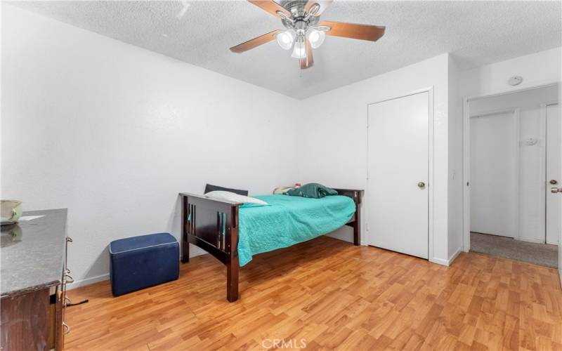 Two of five bedrooms with ceiling fan.