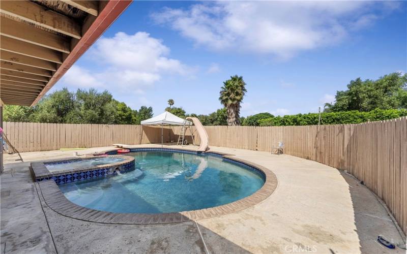 Fenced pool to have fun in or soak in the hot tub to relax.