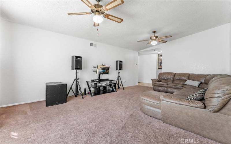 Standing from the formal dining looking at the formal spacious living room.