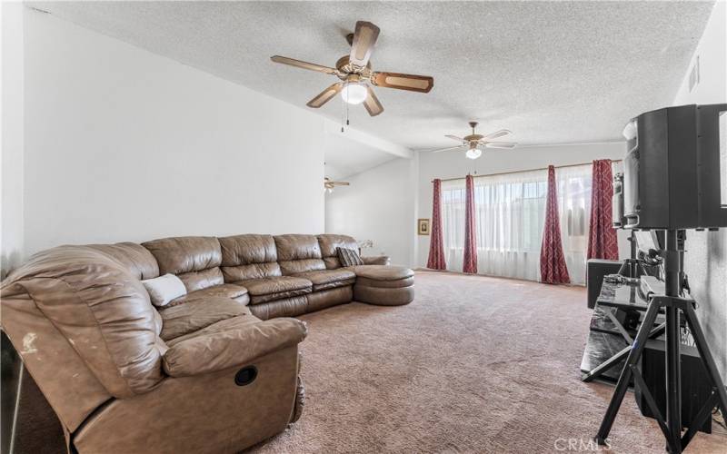 Very roomy formal living room with formal dining around. Rooms have ceiling fans.