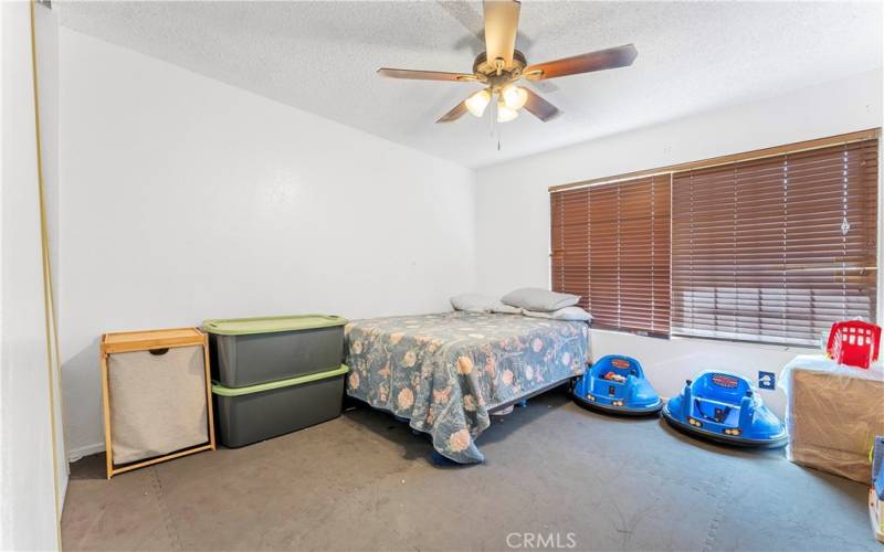 One of five bedrooms with ceiling fan. This room is nearest to the family room.