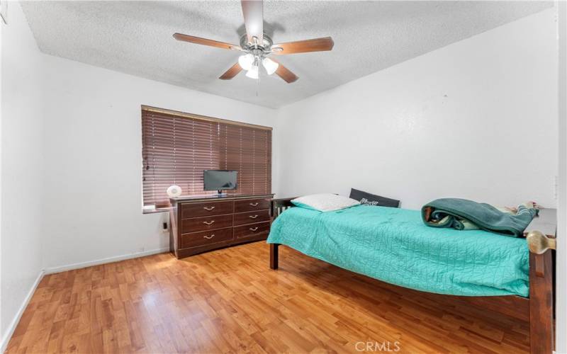 Two of five bedrooms with ceiling fan.