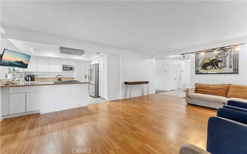 Laminate flooring in family room that opens up to the updated kitchen.